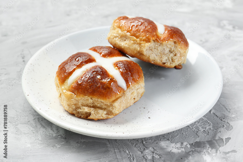 Tasty hot cross buns on gray textured table, closeup