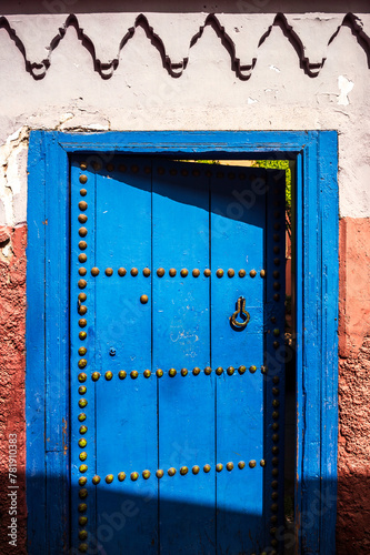 A blue doorway, located in Marrakesh, Morroco, with the harsh desert sun casting stark shadows across the frame