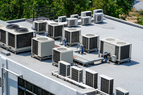 The external units of the commercial air conditioning and ventilation systems are installed on the roof of an industrial building. photo
