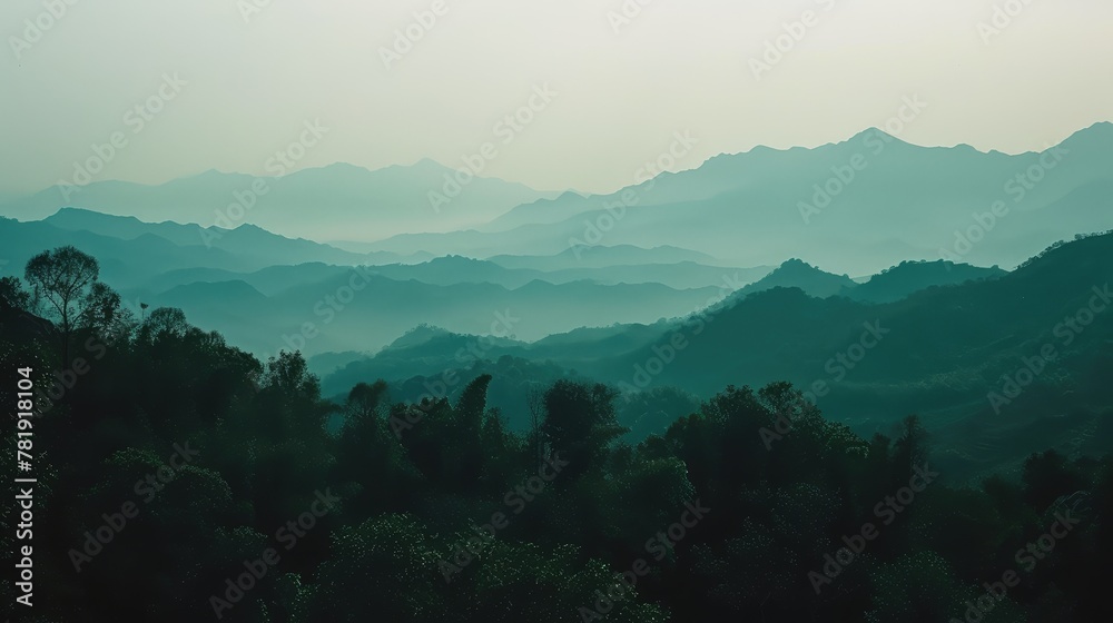 Serene Dawn Mist Over Layered Mountain Range