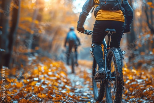 Action shot of mountain bikers riding through a forest with vibrant autumn foliage