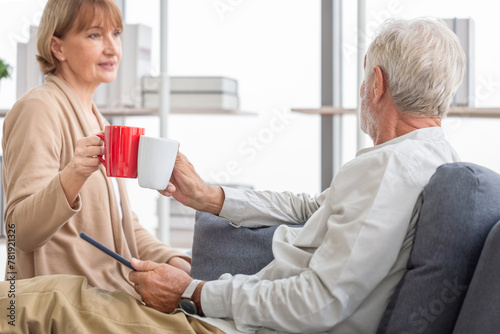 Senior couple spending time together in the living room, Retired man and woman drinking coffee, and tea together, Happy family concepts