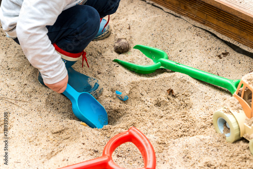 Colorful children's toys in a sandpit