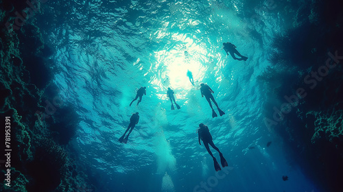 Group of people learning to dive in a pure blue ocean 