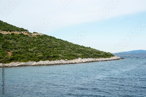 Mesmerizing view of the lake surrounded by a rocky mountainous landscape against a cloudy sky