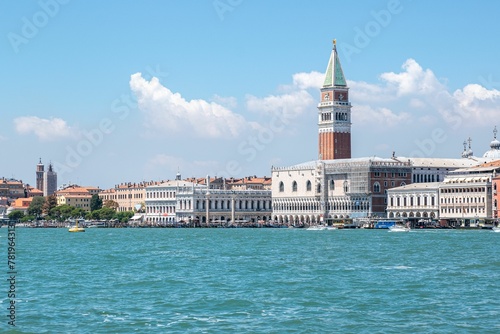 Dramatic shot of St Mark's Campanile in Venice by the river, Italy photo