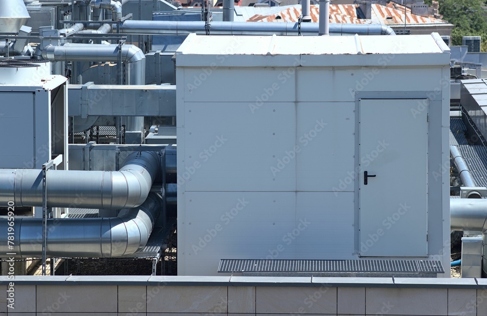 Booth and ventilation system of a building located on the roof against a blue sky Booth and ventilation system of a building located on the roof against a blue sky