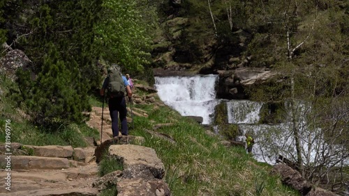 Young male hiker walking down trail in Gradas de Soaso, Ordesa natural park, Spain.