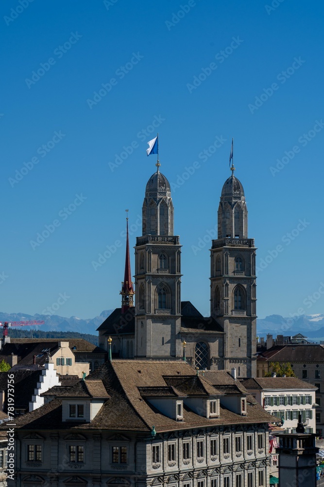 Vertical shot of Grossmunster church against the background of the blue sky. Zurich, Switzerland.