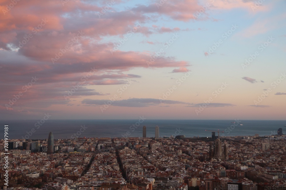 Aerial shot of the La Sagrada Familia church and Barcelona city with the sea in the background