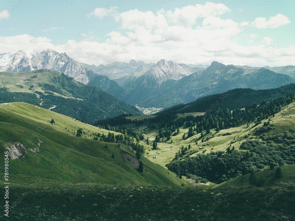 Green valley with the Dolomite Mountains in the background, Italy Green valley with the Dolomite Mountains in the background, Italy