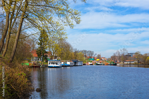 Houseboats and historic sail boats on Burggraben at Stade, Germany