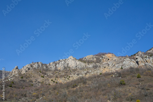 Mountains in spring Crimea against a background of blue sky and bright sunlight © Oksana