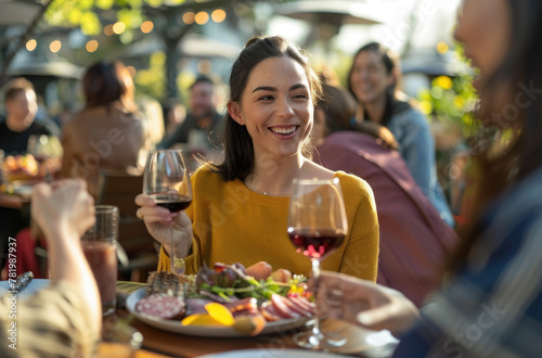 A group of friends are enjoying beer and food at an outdoor restaurant on a sunny day with a cheerful atmosphere