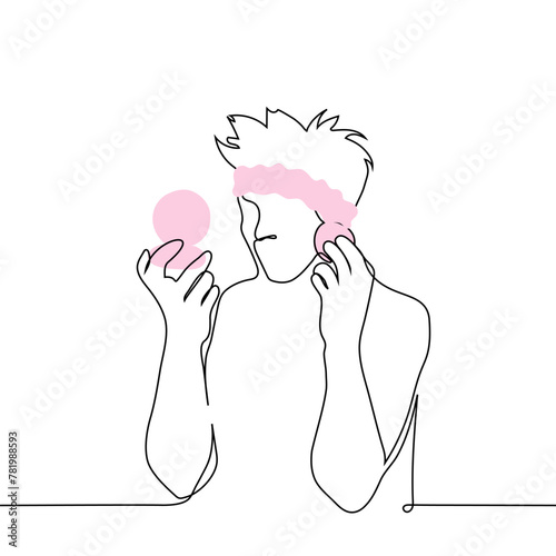 man with a Headband on his head applies makeup - one line art vector. hand-drawn sketch of a man applying blush. male beauty blogger