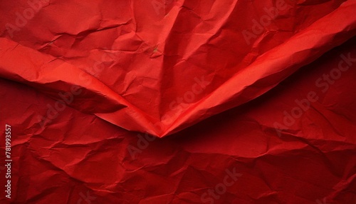 vibrant red paper background, featuring a creased and crumpled surface that adds depth and texture to the composition