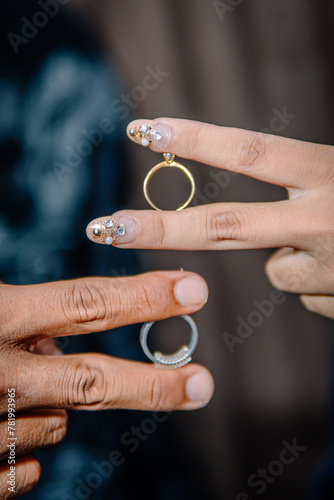 A pair of man and woman are showing their wedding rings