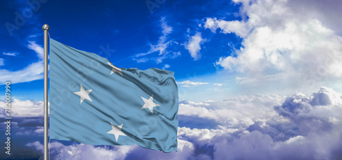 Micronesia, Federated States of Micronesia national flag cloth fabric waving on beautiful Blue Sky Background. photo