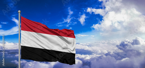 Yemen national flag cloth fabric waving on beautiful Blue Sky Background. photo