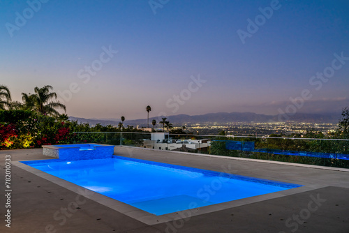 Brightly lit pool under a starry night sky in Encino  California
