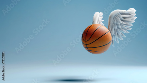 a basketball with angelic wings attached, floating against a blue background © Pari Coo