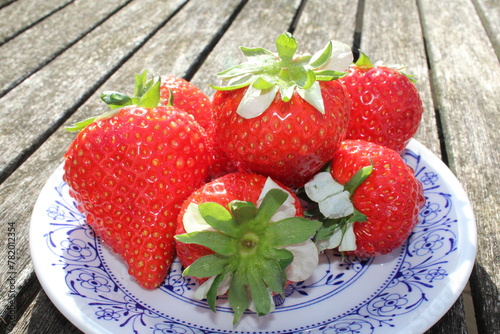 Fresh strawberries on a blue plate
