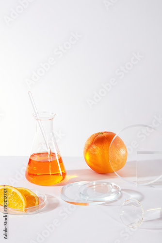 Front view of orange pieces and erlenmeyer on white minimal background. Blank podium for presenting product of orange extract, vitamin C and nutrients for effective skin care.
