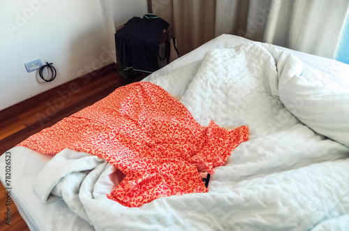 Luxury red woman dress on bed, woman prepare to dress up.  photo