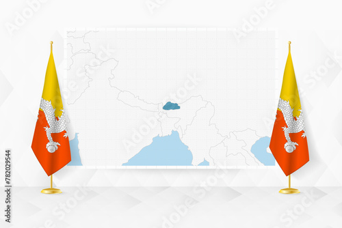 Map of Bhutan and flags of Bhutan on flag stand.
