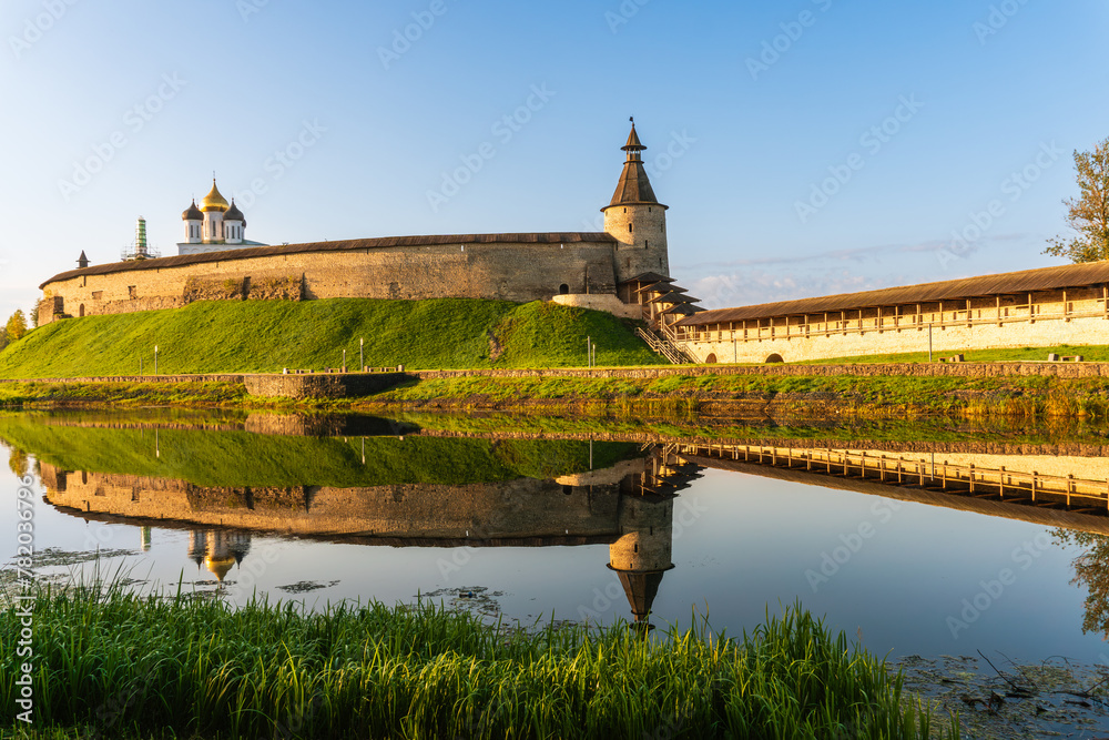 Pskov, Russia, September 11, 2023. Reflection of the walls of the old fortress in the water of the river.