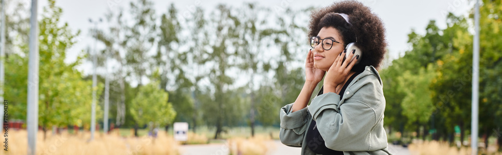 A stylish woman with glasses engages in a music while actively immersed in the urban environment. A stylish woman with glasses engages in a music while actively immersed in the urban environment.