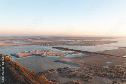 New fertile land and housing for new Dutch residents on Plaat van Walsoorden in the southern region of the Netherlands. Sunrise illuminates the drying areas