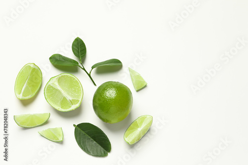 Wallpaper Mural Whole and cut fresh ripe limes with green leaves on white background, flat lay Torontodigital.ca