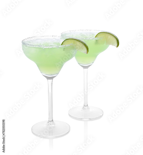 Delicious Margarita cocktail in glasses, salt and lime isolated on white
