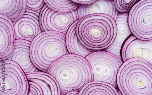 Red onion rings sliced texture background, Group of chopped onion top view © Alex