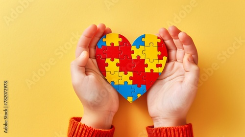 Two small hands holding a heart-shaped puzzle, vibrant in colors, symbolizing love and unity.
