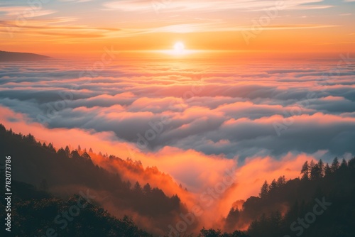 Orange sunlight illuminates the clouds in the mountainous sky
