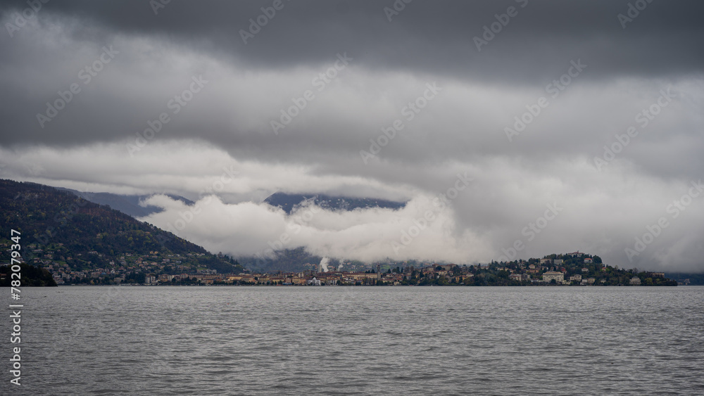 panorama of lake Maggiore on a rainy day with heavy low clouds covering part of the coast panorama of lake Maggiore on a rainy day with heavy low clouds covering part of the coast