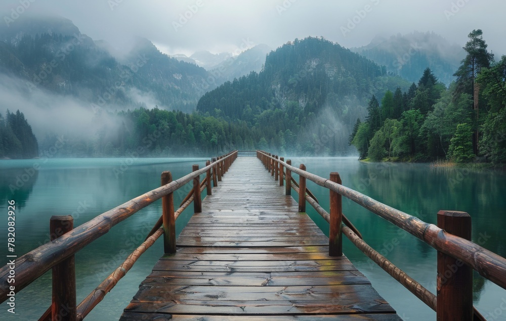 Wooden dock on lake with mountain backdrop, surrounded by natural landscape