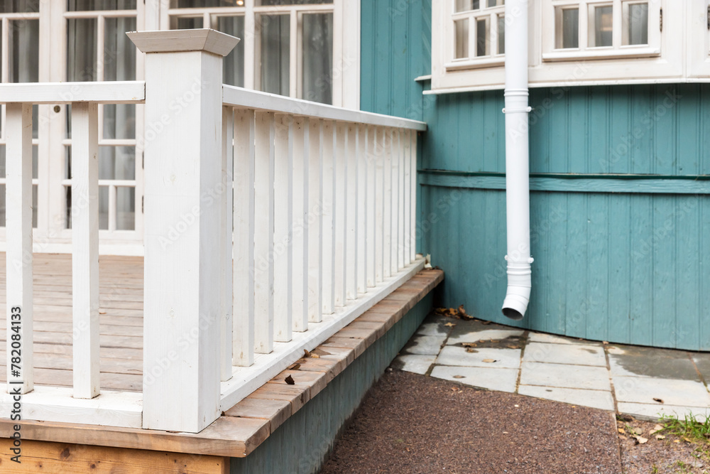 Fototapeta premium Rural wooden house exterior details, white terrace railings