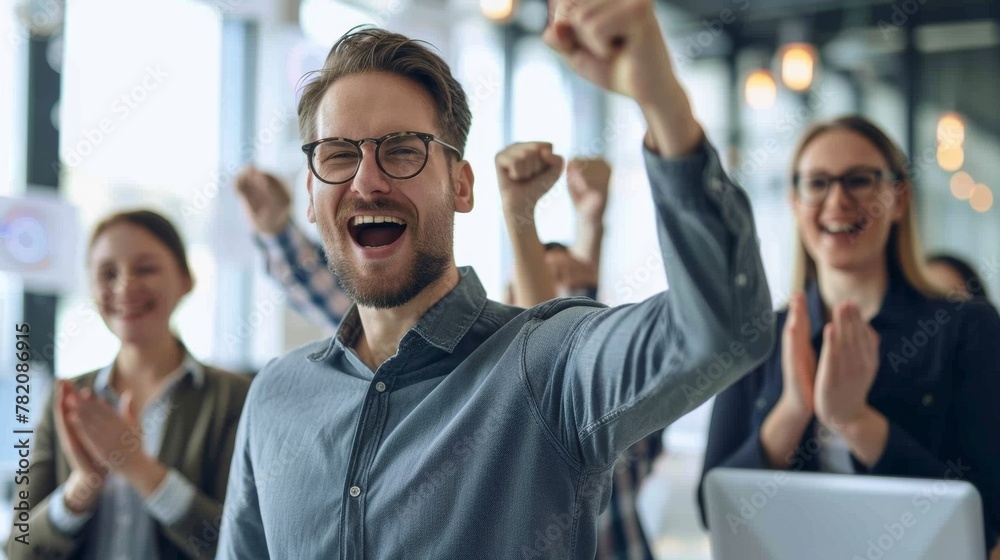 Obraz premium In a scene of jubilation, a triumphant businessman leads his cheering colleagues, their shared success evident in their radiant expressions. 