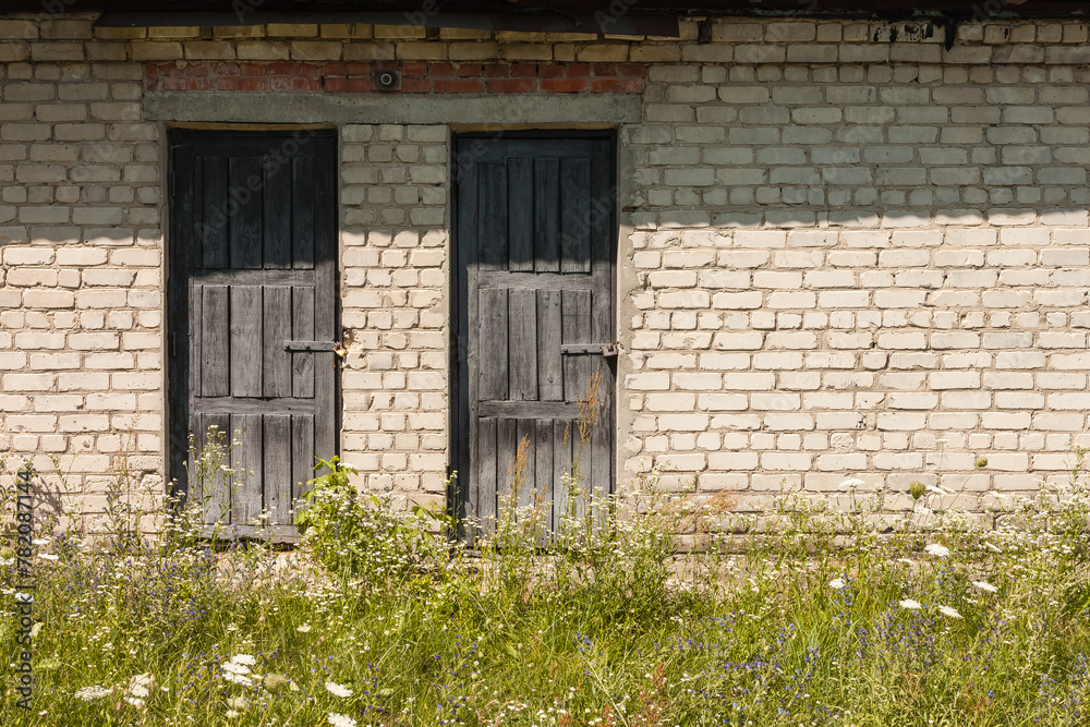 The door of an old brick shed with a wooden frame The door of an old brick shed with a wooden frame
