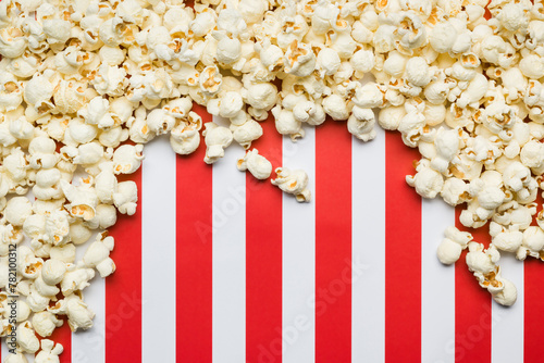 Flat lay composition with popcorn border and copy space on red and white stripes background.