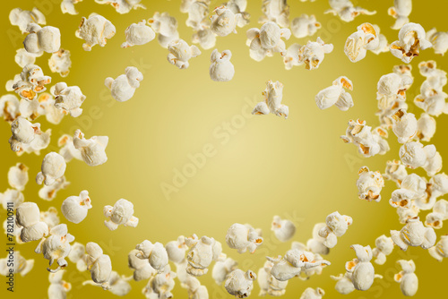 Popcorn frame with copy space, flying popcorn isolated on yellow background.
