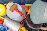 Colorful array of common household items and tools in a disorganized arrangement