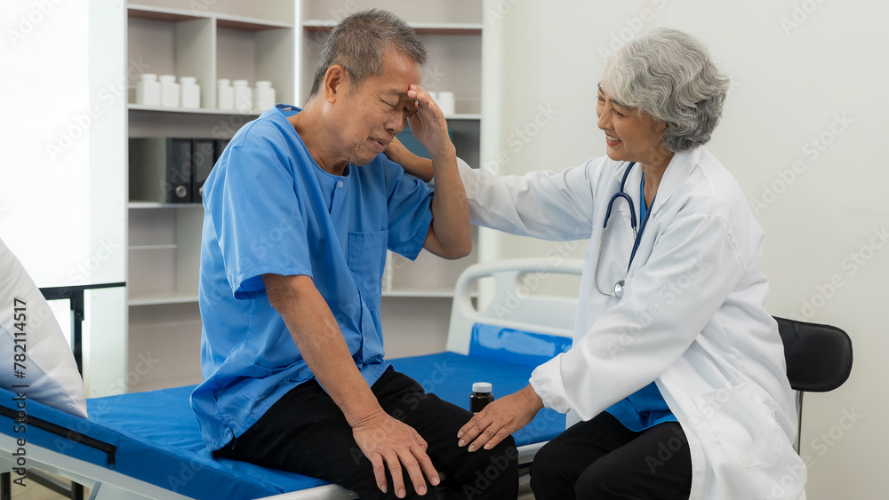 Obraz premium Senior Asian female doctor examining a sick old man in bed, female therapist caring for grandfather in nursing home Health care and health insurance