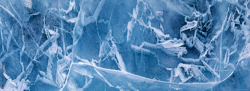 Obraz premium Abstract background of natural winter ice surface. Panoramic wide view from above of ice texture of frozen Baikal Lake. Natural pattern of crack lines, blue and white spots. Flat lay, banner, mock up