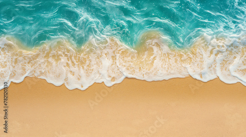 Beach with golden sand washed by turquoise sea wave with white foam