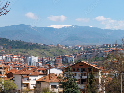 Panorama of Sandanski, Bulgaria on a sunny afternoon with the Pirin Mountains in the backgroud © Amine