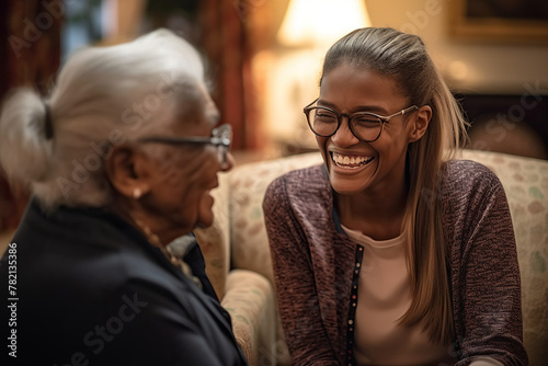 Happy Smiling Elderly Woman Talking To Her Middle-Aged Daughter Indoors
